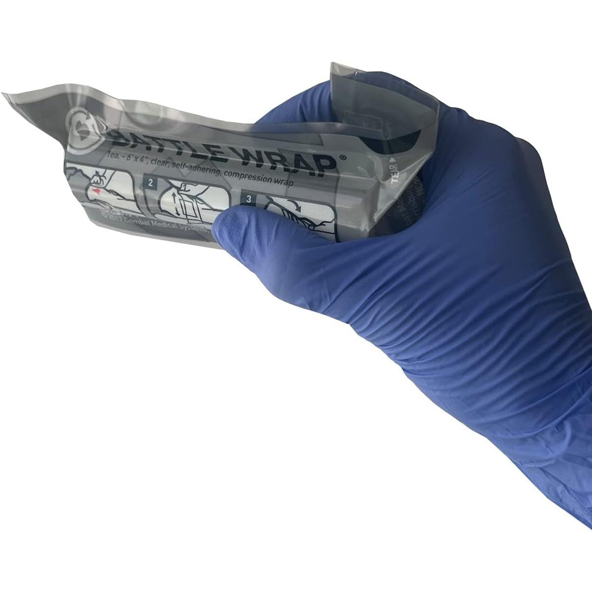 Gloved hand opening the Battle Wrap package, three step application diagram printed on the front