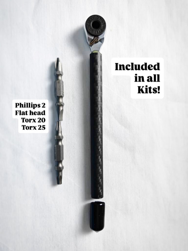 Carbon fiber handle mini ratchet beside its double-ended bits: Phillips 2, flat head, Torx 20 and Torx 25