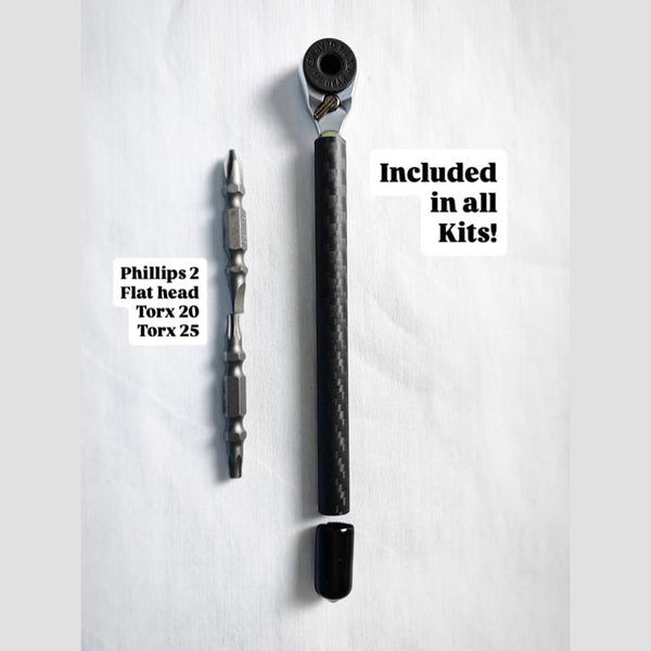 Carbon fiber handle mini ratchet beside its double-ended bits: Phillips 2, flat head, Torx 20 and Torx 25