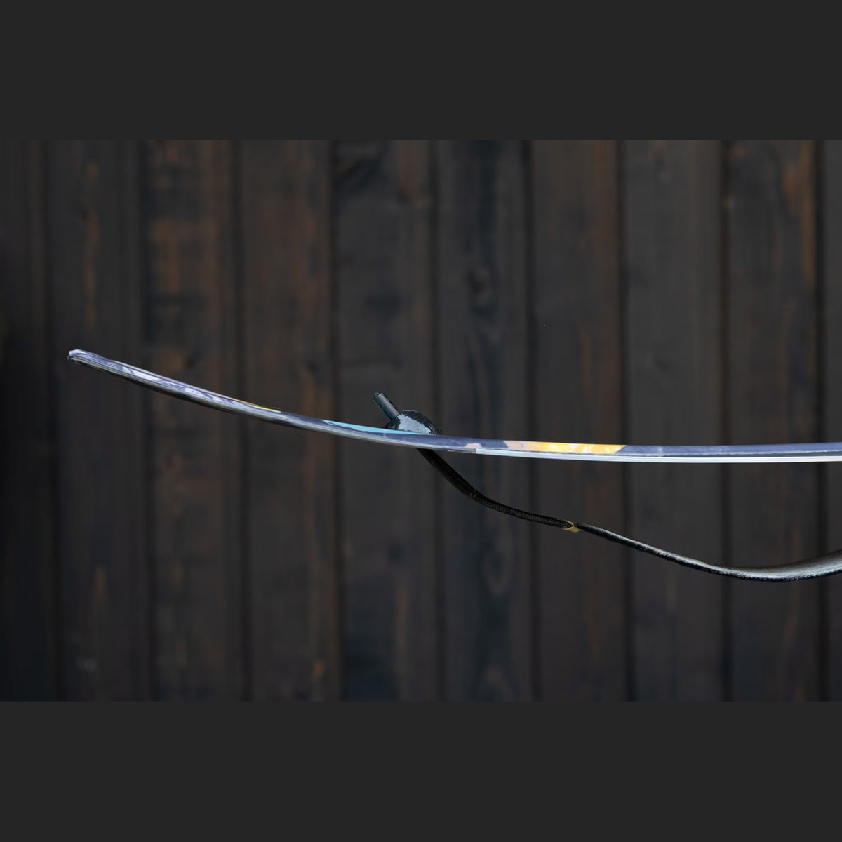 Profile view of a ski tail with the Groovy Lock insert holding a climbing skin flat against the base