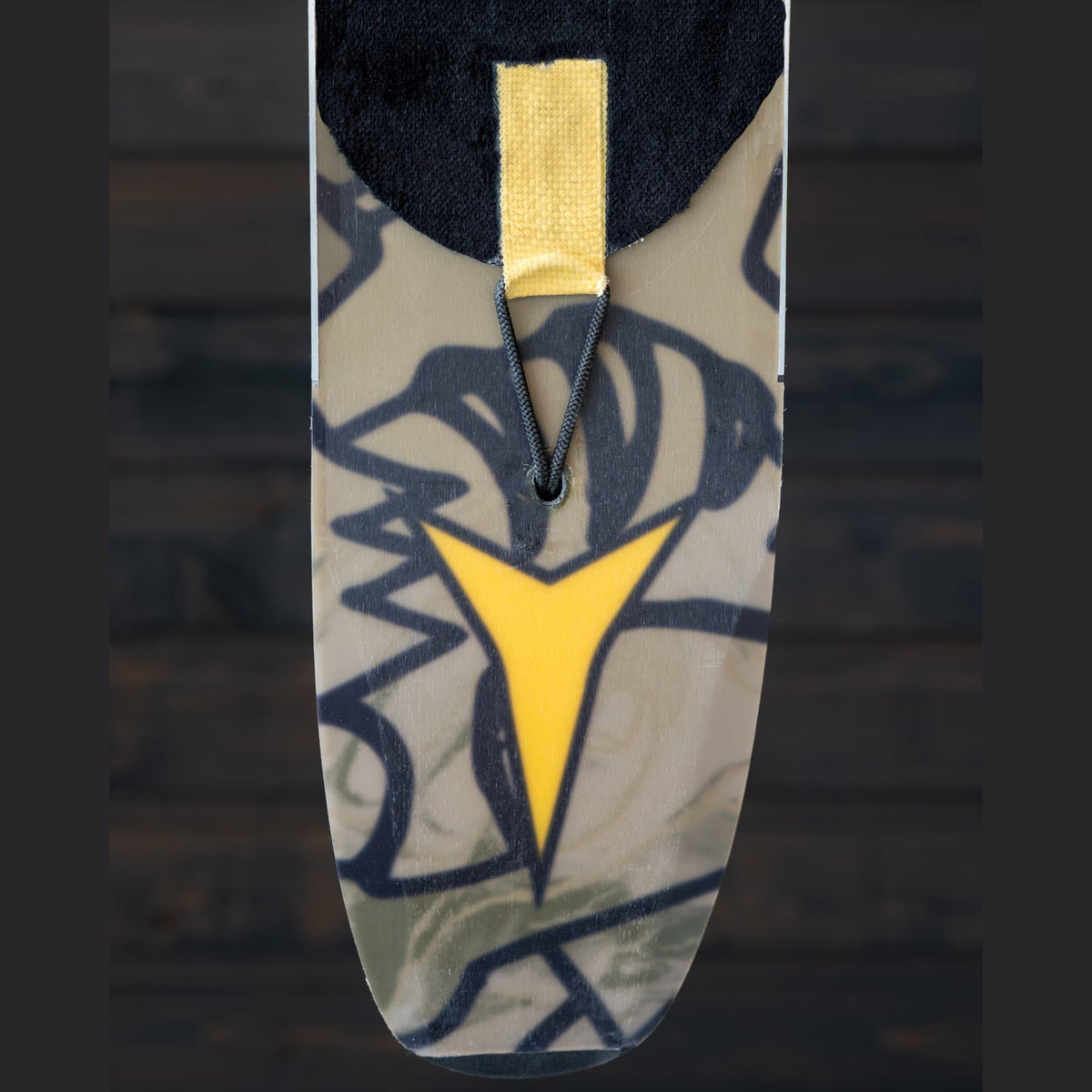 Groovy Lock bungee threaded through a ski tail and clipped to the aramid tail patch of a climbing skin